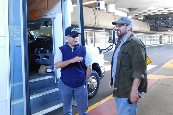 Travelers are taken to curbside in the airport transportation area. At curbside the driver helps with passenger and luggage unload.